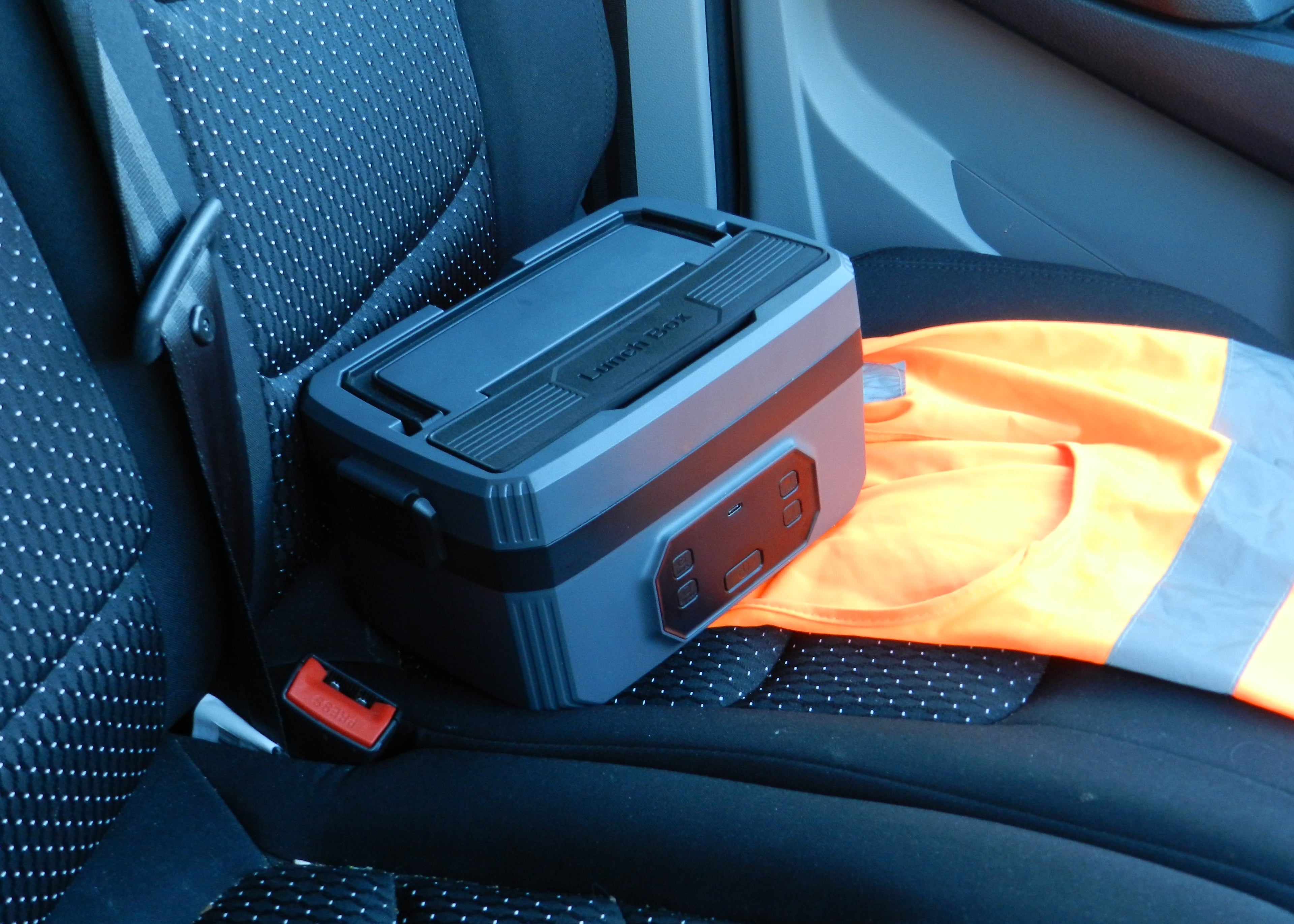 Norva Wireless Heated Lunchbox on a car seat.