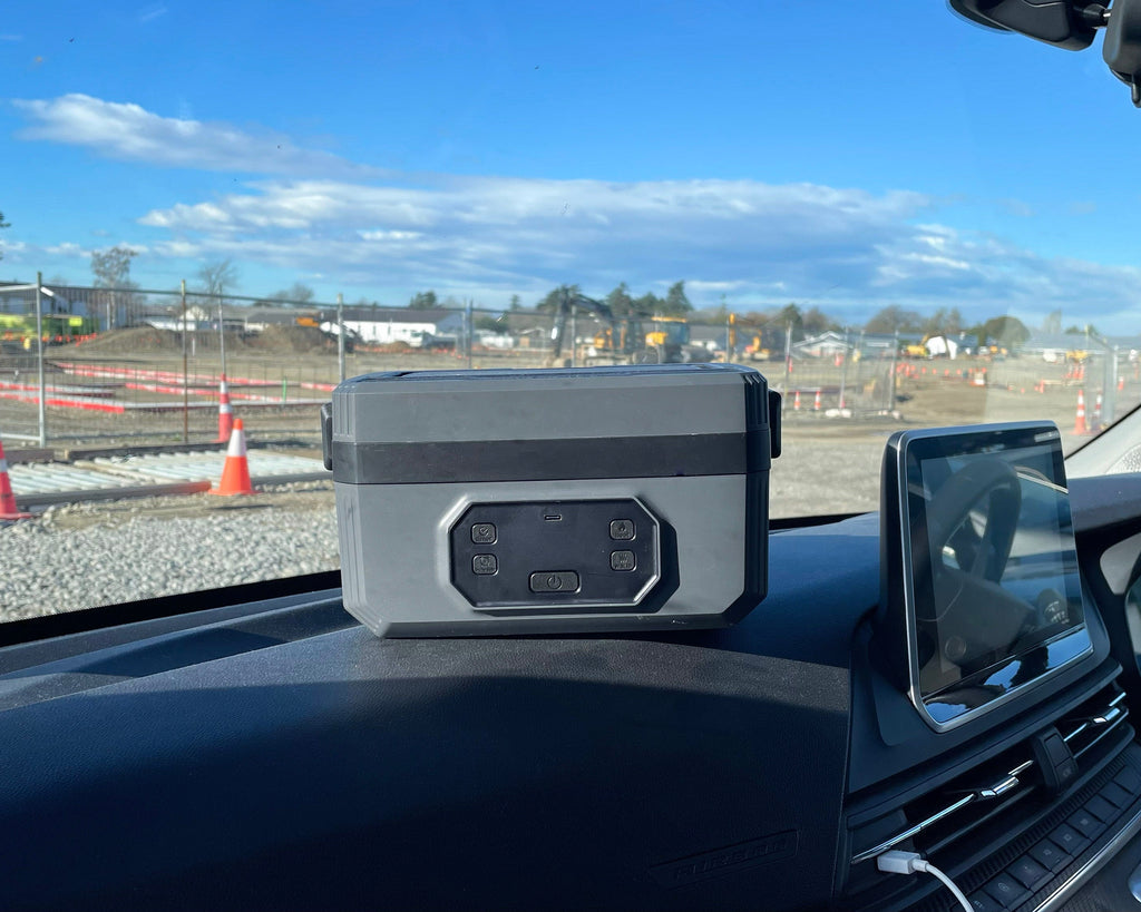Norva Wireless Heated Lunchbox sitting on dashboard of van in construction site. 